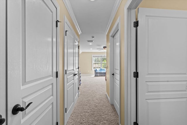 corridor featuring ornamental molding, carpet, and vaulted ceiling