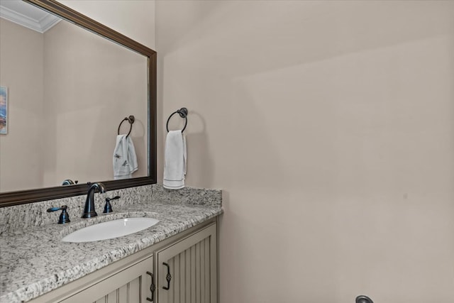 bathroom with crown molding and vanity