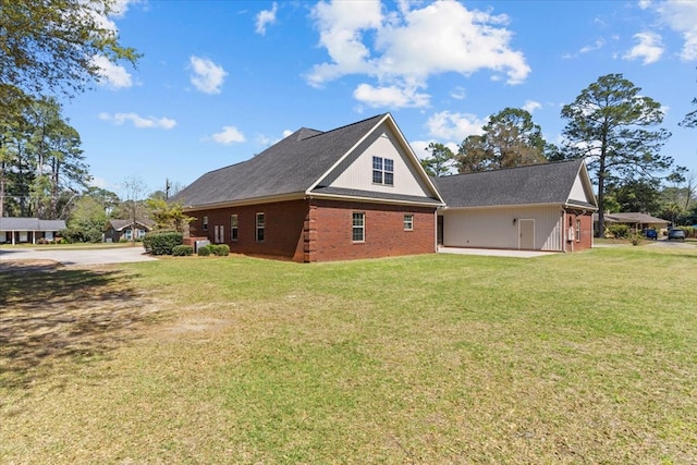 view of home's exterior with driveway, brick siding, and a yard