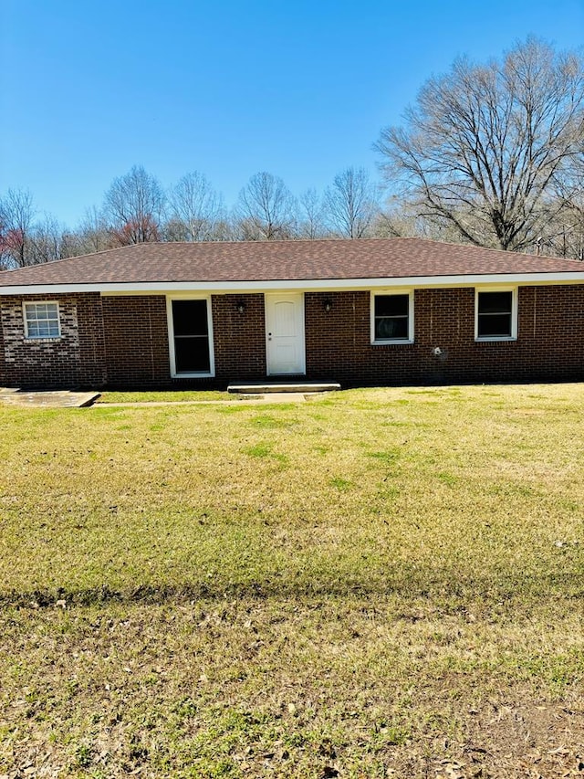 ranch-style home with a front lawn and brick siding