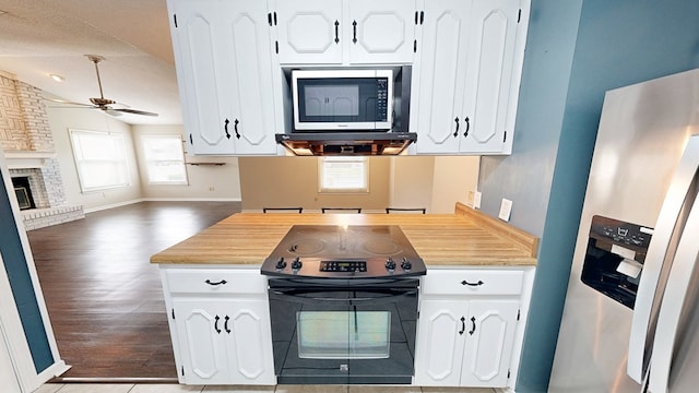 100 W Fontana Cir, Dothan, AL 36305 - kitchen featuring white cabinets, a ceiling fan, light wood-type flooring, appliances with stainless steel finishes, and open floor plan