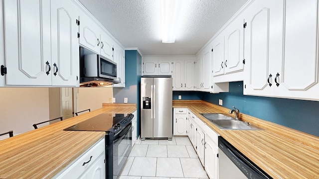 100 W Fontana Cir, Dothan, AL 36305 - kitchen featuring a textured ceiling, white cabinetry, stainless steel appliances, and a sink