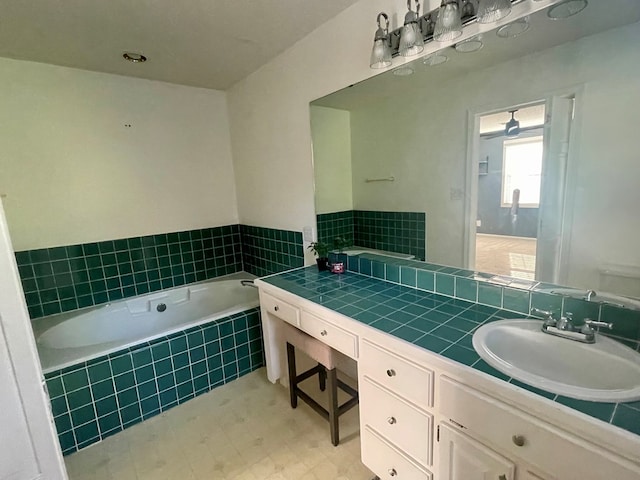 bathroom with vanity and tiled bath