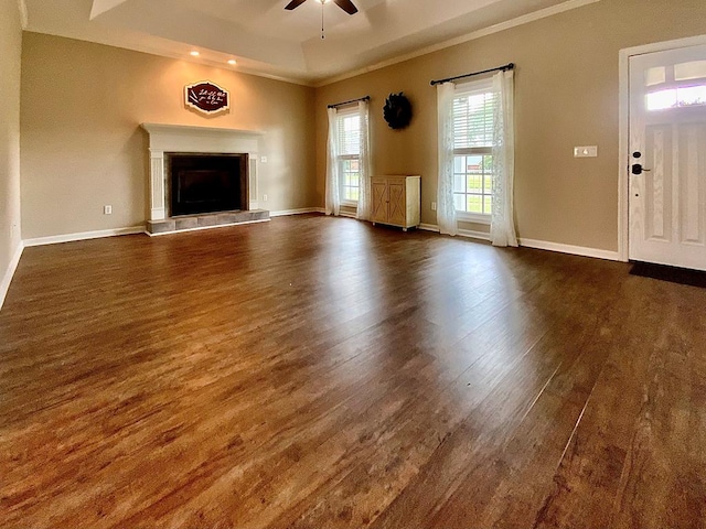 30 Cotton Creek Blvd, Enterprise, AL 36330 - unfurnished living room featuring dark wood-style flooring, a ceiling fan, a fireplace with raised hearth, crown molding, and recessed lighting
