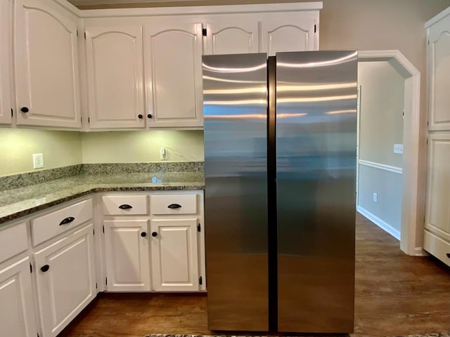 30 Cotton Creek Blvd, Enterprise, AL 36330 - kitchen with freestanding refrigerator, white cabinetry, dark wood-type flooring, and light stone countertops