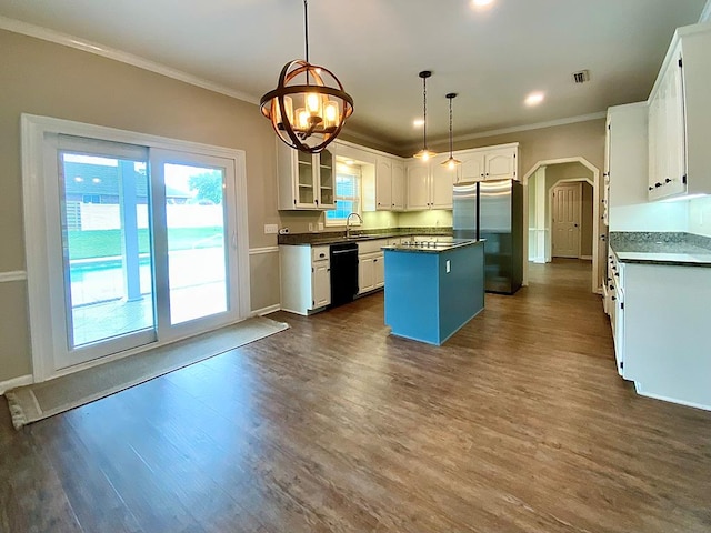 30 Cotton Creek Blvd, Enterprise, AL 36330 - kitchen featuring black dishwasher, freestanding refrigerator, dark countertops, arched walkways, and a kitchen island