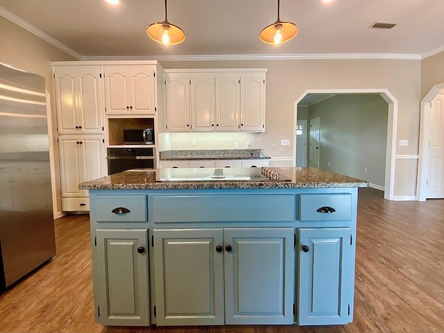 30 Cotton Creek Blvd, Enterprise, AL 36330 - kitchen featuring stainless steel appliances, white cabinetry, arched walkways, wood finished floors, and crown molding