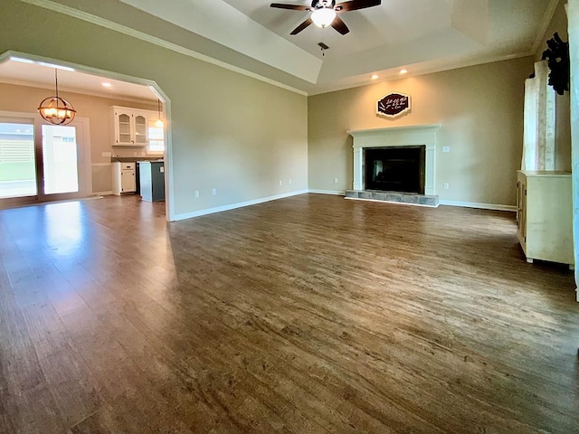 30 Cotton Creek Blvd, Enterprise, AL 36330 - unfurnished living room with a raised ceiling, ceiling fan, a glass covered fireplace, a chandelier, and dark wood-style floors