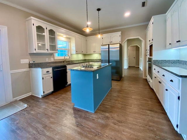 30 Cotton Creek Blvd, Enterprise, AL 36330 - kitchen featuring black appliances, a kitchen island, ornamental molding, arched walkways, and glass insert cabinets