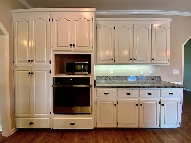 30 Cotton Creek Blvd, Enterprise, AL 36330 - kitchen with stainless steel appliances, white cabinetry, dark stone countertops, dark wood-style flooring, and crown molding