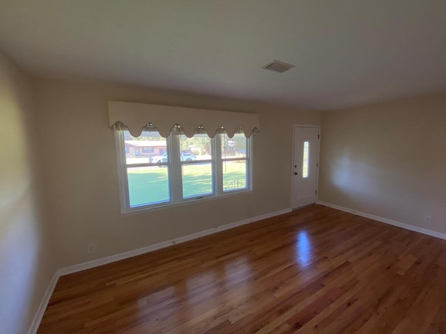 unfurnished room featuring hardwood / wood-style floors