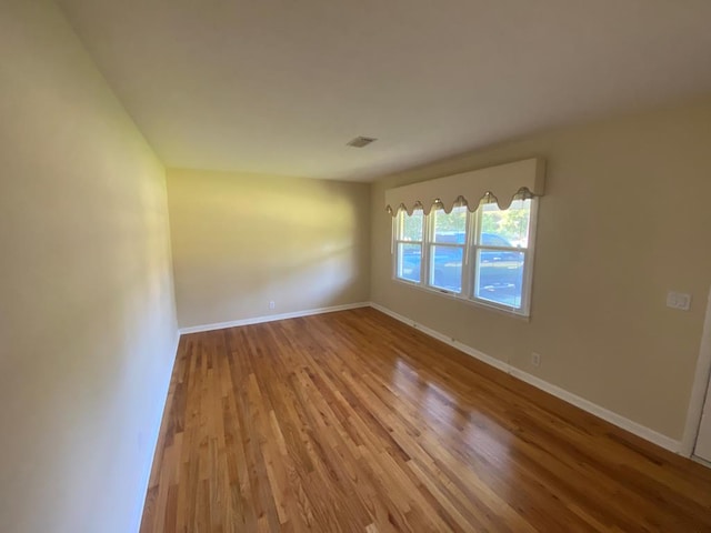 empty room with light hardwood / wood-style flooring