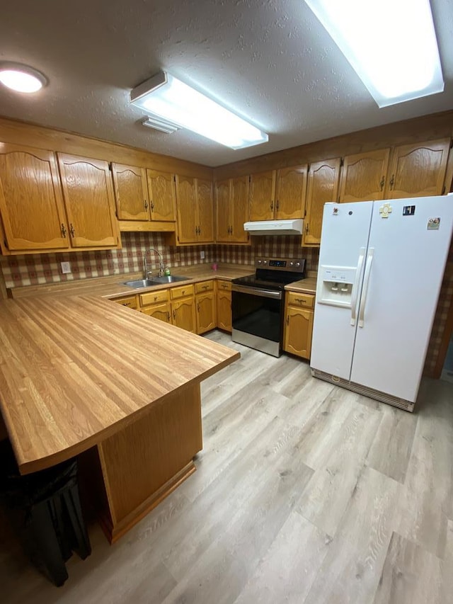 kitchen featuring kitchen peninsula, sink, white refrigerator with ice dispenser, electric range, and light hardwood / wood-style floors