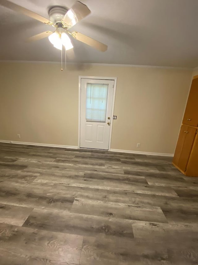 interior space featuring crown molding, ceiling fan, and dark wood-type flooring