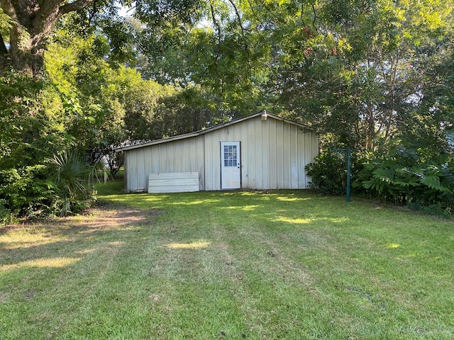 view of outbuilding featuring a yard