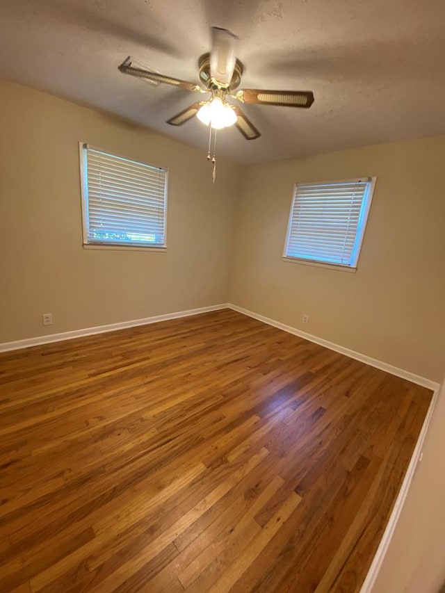 unfurnished room with wood-type flooring and ceiling fan