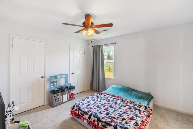 bedroom featuring ceiling fan and light carpet