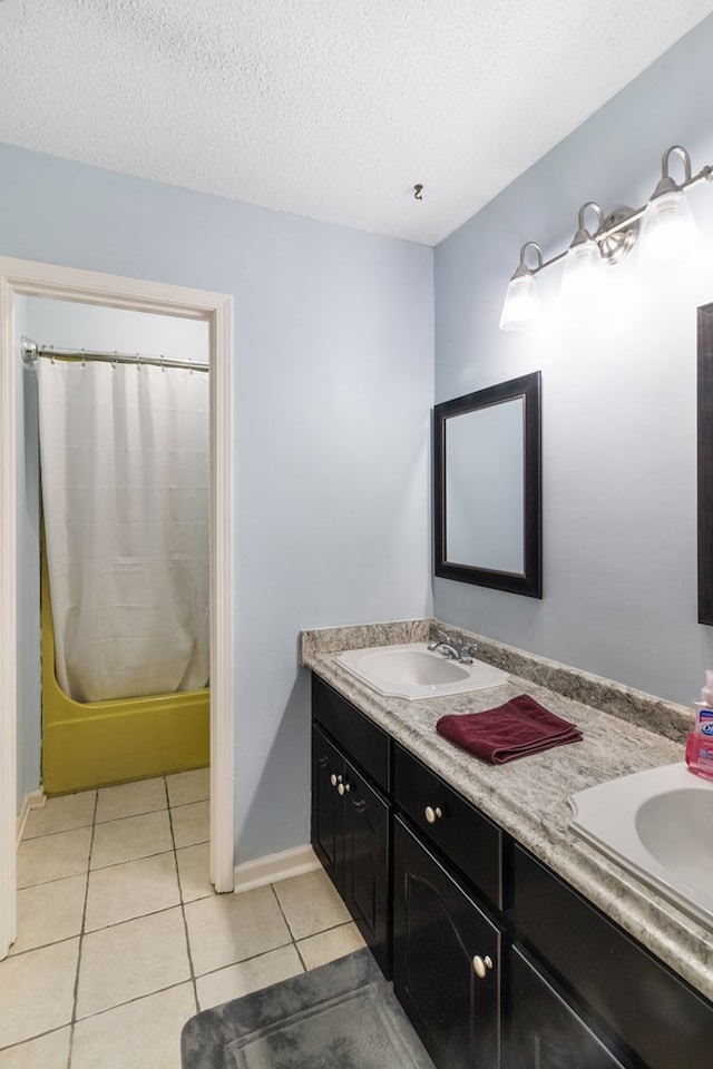 bathroom featuring a textured ceiling, tile patterned flooring, vanity, and shower / bath combo