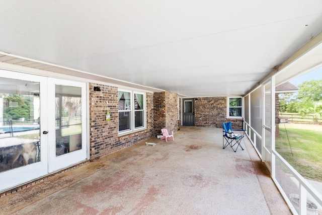 unfurnished sunroom featuring a wealth of natural light and french doors