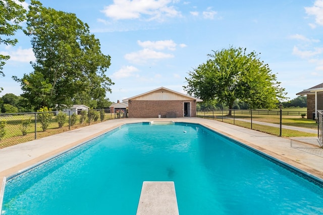 view of pool featuring a diving board and a patio area