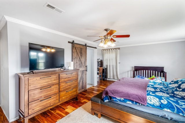 bedroom with a barn door, ceiling fan, dark hardwood / wood-style floors, and ornamental molding