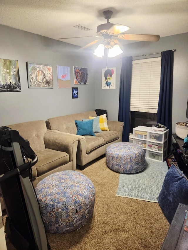 living room with a textured ceiling, visible vents, and ceiling fan