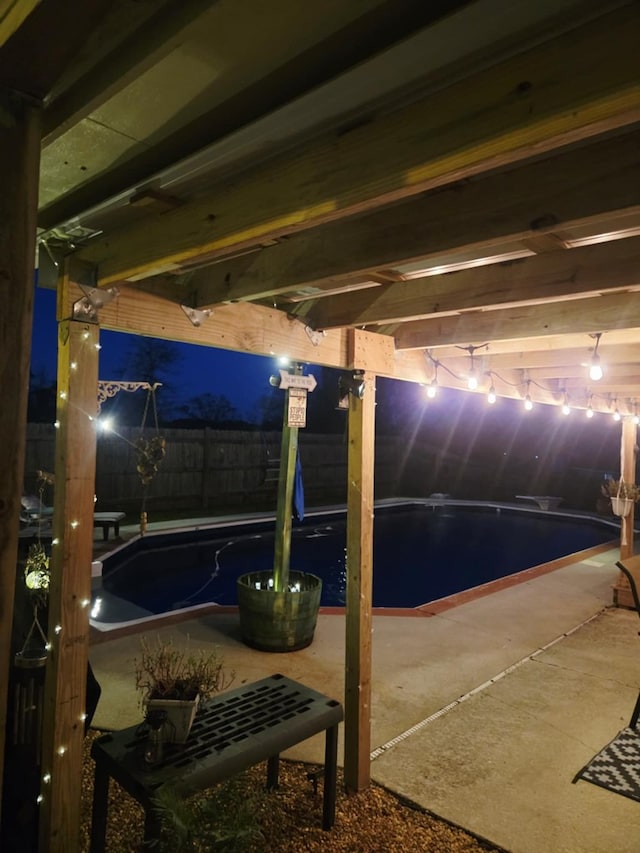 patio at twilight featuring fence