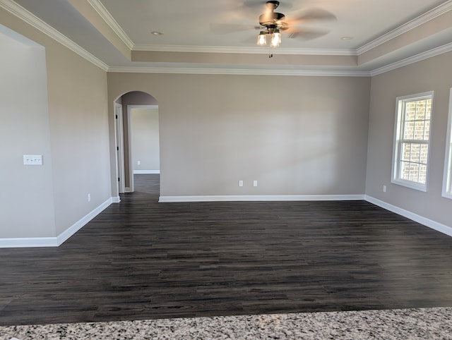 12589 Fortner St, Newton, AL 36352 - unfurnished room with dark wood-type flooring, arched walkways, a tray ceiling, a ceiling fan, and baseboards