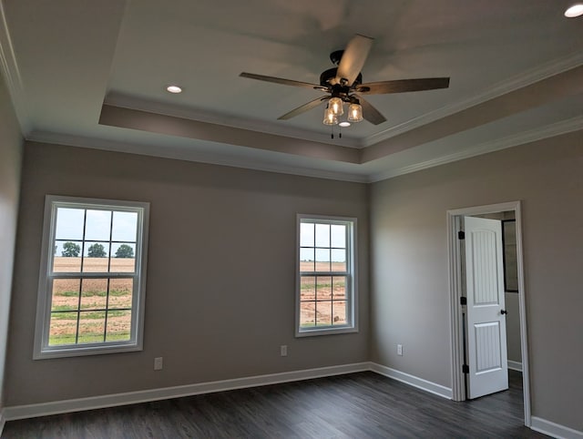 12589 Fortner St, Newton, AL 36352 - spare room featuring dark wood-type flooring, ceiling fan, a tray ceiling, ornamental molding, and baseboards