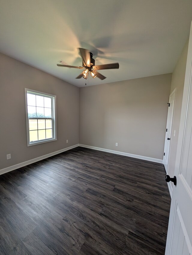 12589 Fortner St, Newton, AL 36352 - unfurnished room featuring a ceiling fan, dark wood-type flooring, and baseboards