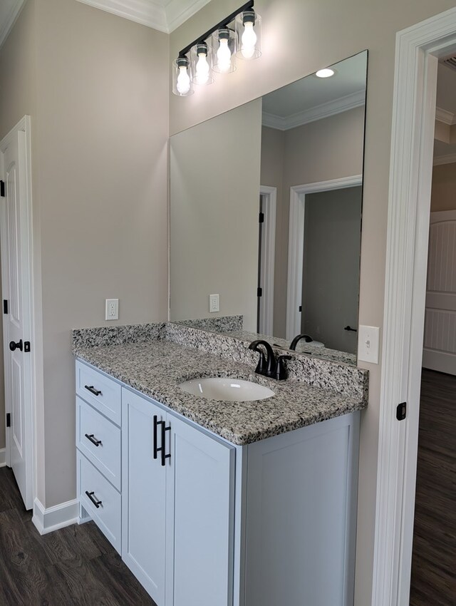 12589 Fortner St, Newton, AL 36352 - bathroom featuring ornamental molding, wood finished floors, vanity, baseboards, and recessed lighting