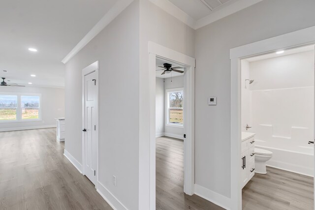 unfurnished living room with ceiling fan, light wood-type flooring, crown molding, and french doors