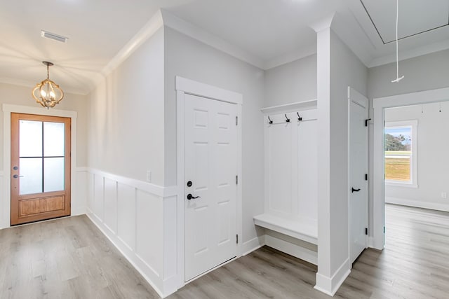 mudroom featuring crown molding, an inviting chandelier, and light hardwood / wood-style flooring