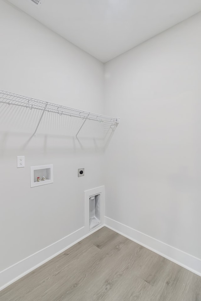 washroom with electric dryer hookup, washer hookup, and light hardwood / wood-style floors