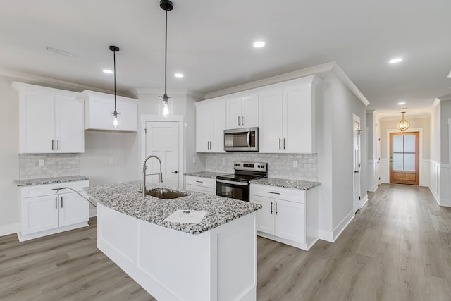 kitchen with electric stove, sink, white cabinetry, and light stone countertops