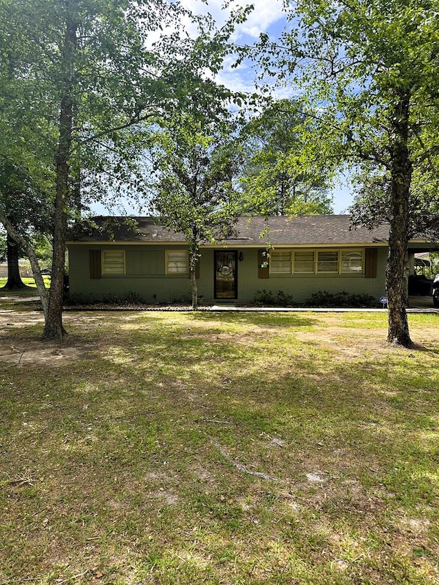 ranch-style home with a front lawn