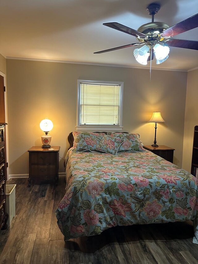 bedroom featuring ceiling fan, dark hardwood / wood-style flooring, and ornamental molding