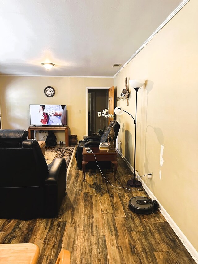 living room with hardwood / wood-style floors and crown molding