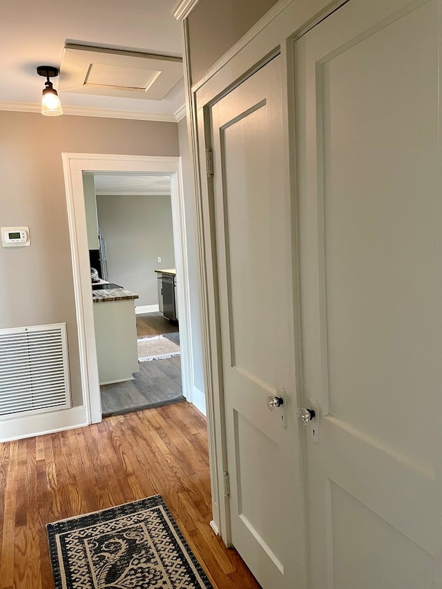 corridor featuring crown molding and light wood-type flooring