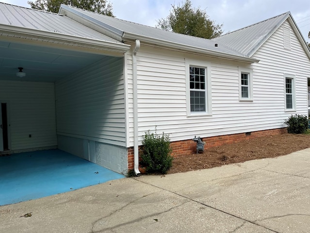 view of side of home featuring a carport