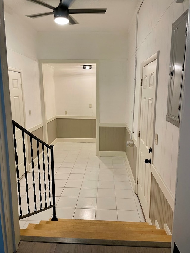 hall with electric panel and light tile patterned flooring