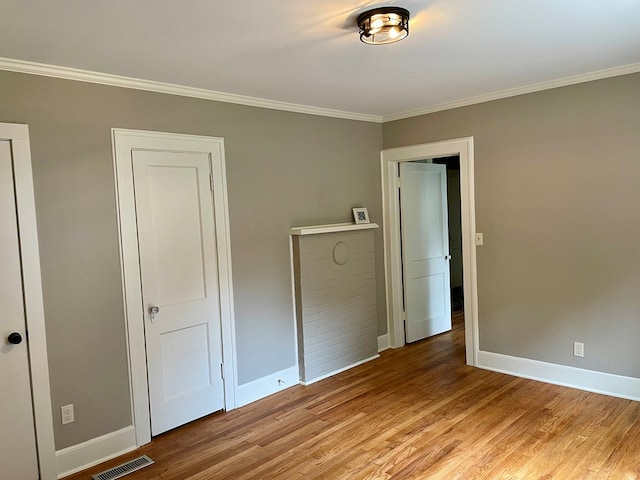 unfurnished bedroom with light hardwood / wood-style floors and ornamental molding