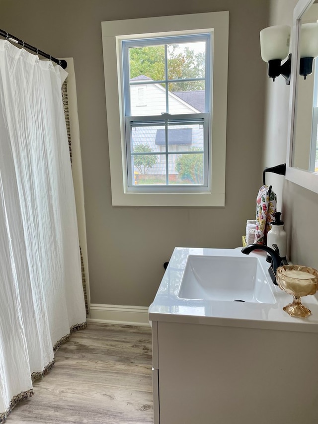 bathroom featuring hardwood / wood-style flooring and vanity