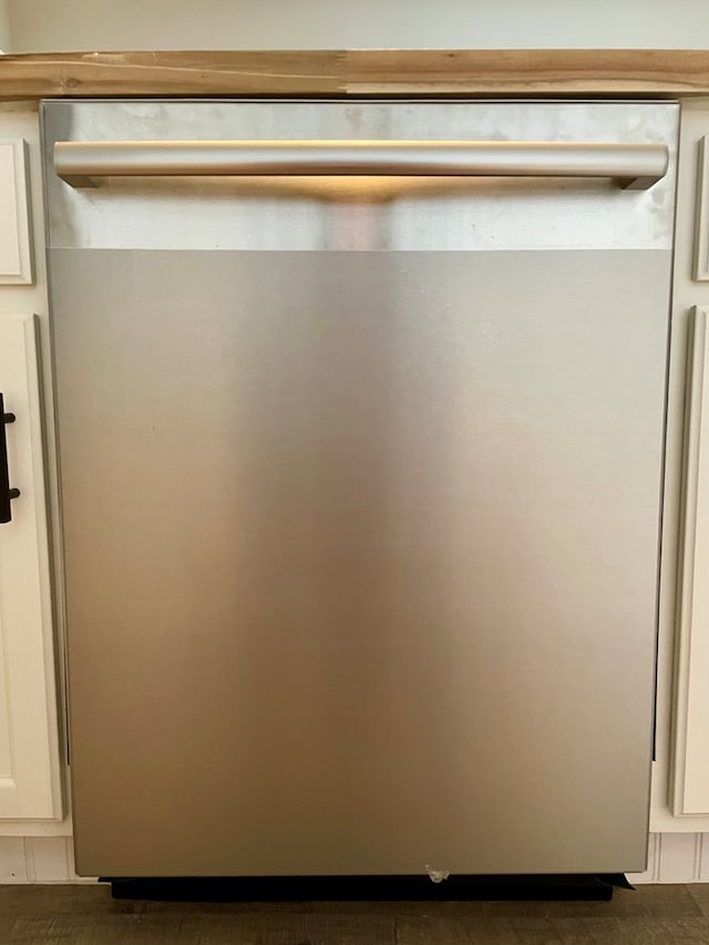 details with white cabinetry and stainless steel dishwasher