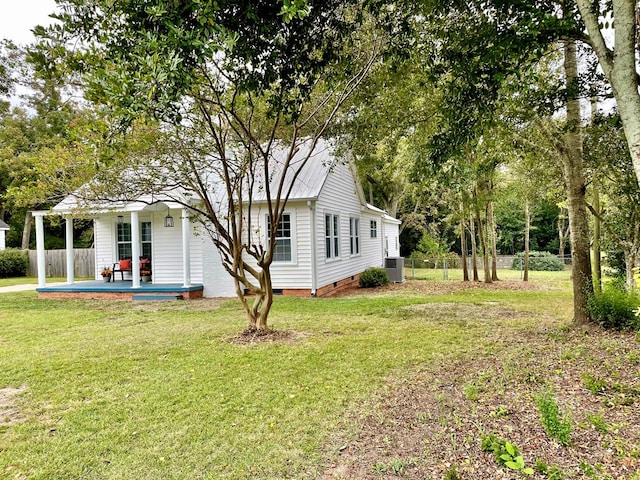 exterior space with a lawn and central AC unit