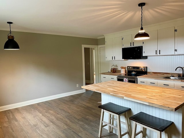 kitchen with wooden counters, ornamental molding, sink, hardwood / wood-style flooring, and stainless steel electric range oven