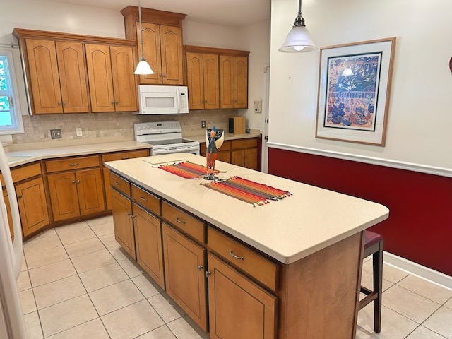 kitchen featuring decorative backsplash, white appliances, a kitchen island, and brown cabinets