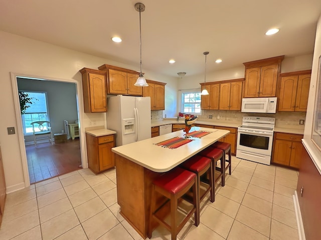 kitchen featuring brown cabinetry and white appliances