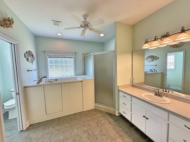 full bathroom featuring visible vents, toilet, a garden tub, a stall shower, and vanity