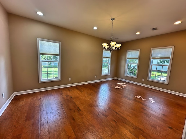 empty room featuring visible vents, recessed lighting, baseboards, and dark wood-style flooring